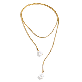 A gold-toned double-strand rope chain necklace with two dangling white baroque pearls, shown on a plain white background.