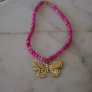 Lola Butterfly Gemstone Necklace with bright pink beads and gold butterfly pendant