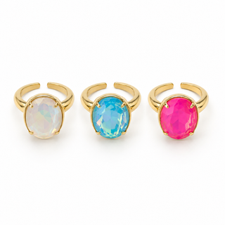 Three gold rings with colorful gemstones on a white background