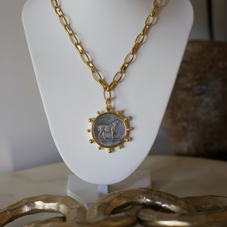 Heritage Horse Coin Necklace with a gold-plated chain and detailed horse pendant on a white display stand