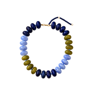 A beaded necklace featuring alternating sections of dark navy blue, light blue, olive green, and gold-toned spacer beads, arranged in a circle on a plain white background.