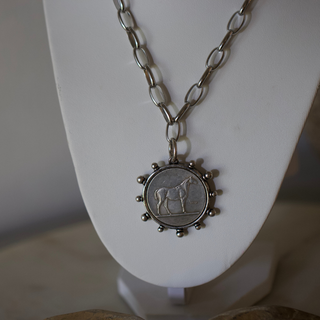 Silver Heritage Horse Coin Necklace with detailed horse on round pendant, stainless steel chain on white bust.