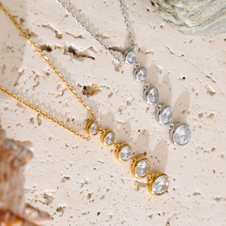 Gold and silver Juliette Drop Necklace with graduated bezel-set clear stones in a delicate lariat design