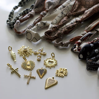 Multiple colored scarfs with various scarf charms