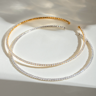 Two Glimmer Flex Choker necklaces, one 18k gold plated, one silver-toned, both with dazzling rhinestones on white