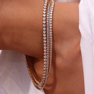 Close-up of a person wearing multiple diamond bracelets on a white background