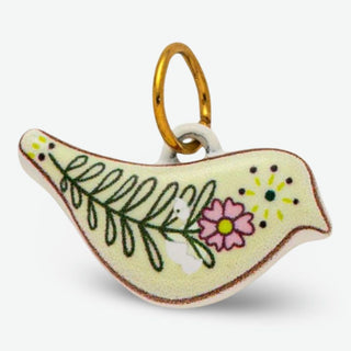 Handcrafted ceramic bird charm cream dove with pink floral and green leaf detailing on stainless steel ring
