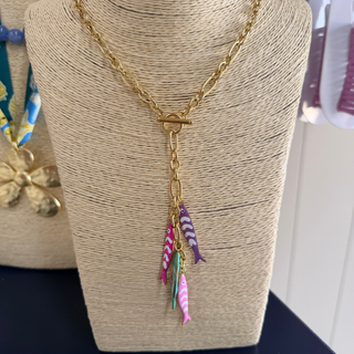 Gold-tone Finley Fish Lariat Necklace with pink, purple, turquoise, and soft pink fish charms on front toggle closure chain