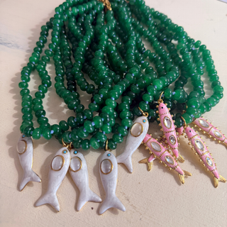 Maris Fish Beaded Necklace with glossy deep green beads and pink fish charm on 18-inch hand-beaded coastal style chain