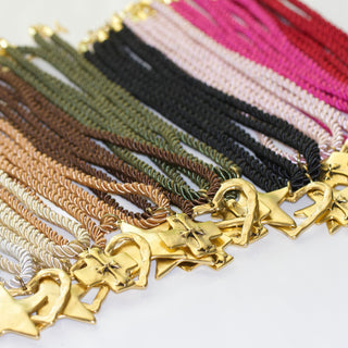 Collection of different colored silk cord necklaces with pendents 