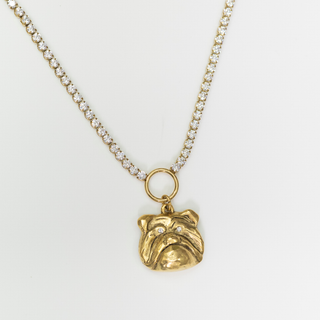 A gold necklace featuring a small bulldog pendant with tiny clear stones, displayed on a clean white background.