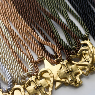 Silk cord necklaces in different colors with various pendants. 