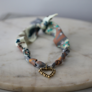 Beaded Heart Scarf Necklace with a twisted multicolour patterned fabric band and gold-tone beaded heart pendant