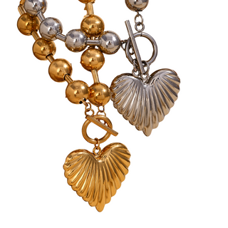 Beaded Heart Statement Necklace with chunky gold and silver beads and two ribbed, shell-shaped heart pendants