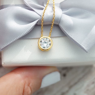 Bezeled CZ Pendant necklace with a gold-tone bezel-set clear round stone and delicate matching chain