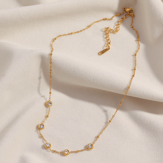 Bezeled Lilylight Necklace in gold-tone metal with a fine chain and sparkling round stones in delicate bezels