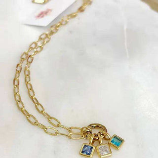 Birthstone Necklace Bar Kit featuring a gold-tone paperclip chain and three rectangular blue, teal, and clear stone charms
