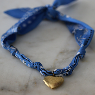 Blue Skies Heart Locket scarf necklace with a twisted blue patterned fabric band and a gold-tone heart pendant