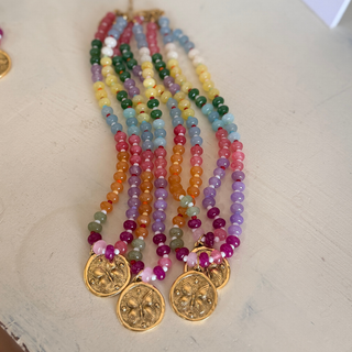 Butterfly Kisses Beaded Necklace with glossy multicolor beads and three round gold-tone butterfly medallions