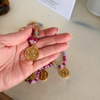 Butterfly Kisses Beaded Necklace with glossy multicolor round beads and a textured round gold-tone butterfly medallion