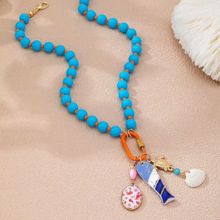 Cabana Charm Necklace with bright turquoise beads, gold-tone links, orange carabiner clasp, and colorful coastal charms