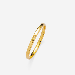 Center Stone Bangle Bracelet in polished gold-tone metal with a slim oval band and a small round center stone