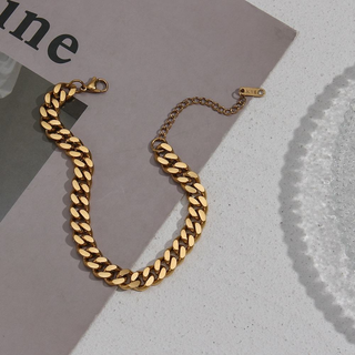 Curb Chain Anklet in polished gold-tone metal with bold, closely linked oval links and an adjustable chain clasp