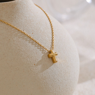 Dainty Cross Necklace with a fine gold-tone chain and petite polished cross pendant, featuring a minimalist design.