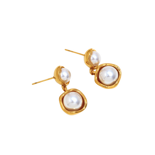 Double Pearl Drop Earrings in gold-tone metal with two round white pearls and rounded polished frames for a sculptural look