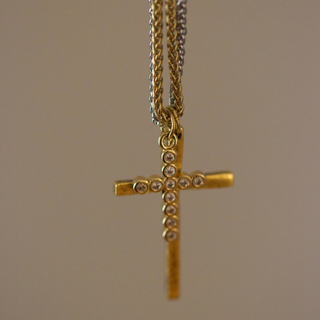 Dual Cross Necklace with a gold-tone cross pendant and silver-toned accents, set with clear stones on layered chains