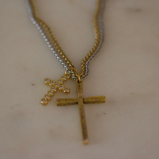 Dual Cross Necklace with layered gold and silver chains, featuring a plain gold cross and a smaller crystal-accented cross