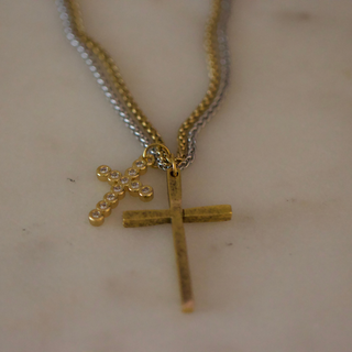 Dual Cross Necklace with two gold-tone crosses, one textured and one set with small clear stones, on mixed metal chains