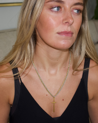 Elle Double Chain Cross Necklace in gold and silver metal, featuring fine layered chains and a slim gold cross pendant