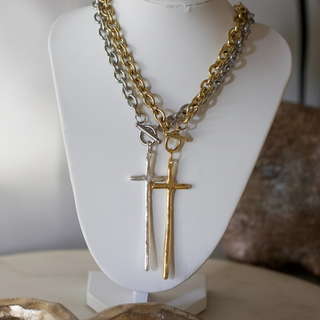 Elongated Cross Toggle Necklace with layered gold- and silver-tone chains, toggle clasps, and slim cross pendants