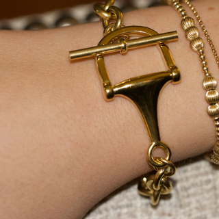 Equestrian Horse Bit toggle bracelet in polished gold-tone metal, featuring a sculptural horse bit link and chunky chain