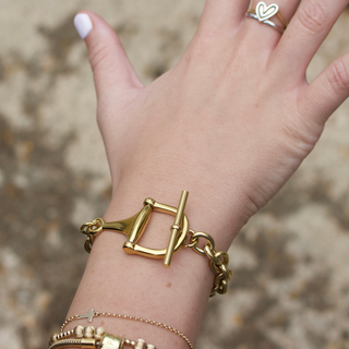 Equestrian Horse Bit toggle bracelet in gold-tone metal, featuring chunky links and a distinctive bar closure