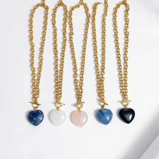 Gemstone Heart Toggle Necklace in gold-tone chunky chain with toggle clasps and blue, white, pink, and black heart pendants