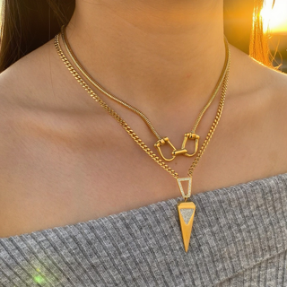 Geo Point Pendant necklace with a gold-tone geometric pointed drop and textured triangular detail on layered chains