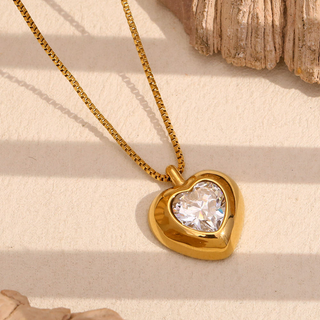 Gold Heart Crystal Necklace with a polished gold heart pendant, clear faceted crystal center, and fine box chain
