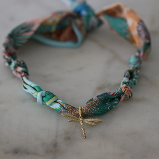 Golden Dawn Dragonfly scarf necklace with a multicoloured patterned fabric cord and a small gold-tone dragonfly pendant