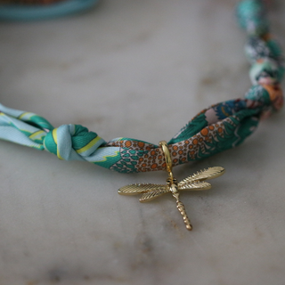 Golden Dawn Dragonfly scarf necklace with a teal, aqua and rust floral-print fabric cord and gold-tone dragonfly pendant