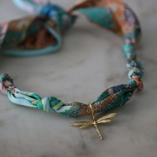 Golden Dawn Dragonfly scarf necklace with a knotted teal and multicolour patterned fabric cord and gold-tone dragonfly charm