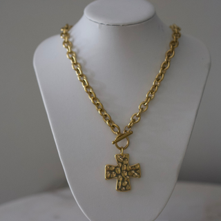 Hammered Cross Toggle necklace in gold-tone metal, featuring a chunky chain, textured cross pendant, and toggle clasp.
