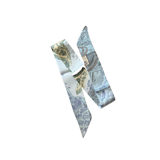 Heritage Map Scarf in pale blue and cream silk-like fabric, printed with intricate vintage map and cityscape patterns.