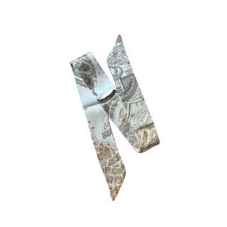 Heritage Map Scarf, a narrow silk-like twilly in pale blue, ivory, and tan with intricate vintage map patterns