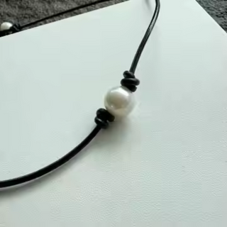 Hometown Pearl Choker with a thin black leather cord and one round ivory freshwater pearl between dark knots