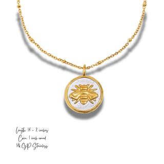 Honeymark Necklace with a gold beaded chain and round two-tone coin pendant featuring a raised golden bee