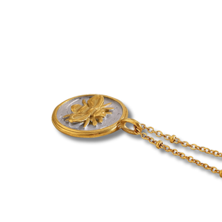 Honeymark Necklace with a gold-tone chain and round two-tone coin pendant featuring a raised golden bee