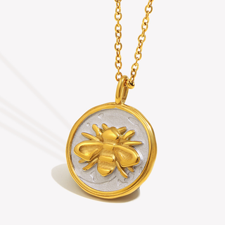 Honeymark Necklace with a two-tone round coin pendant, raised gold bee, silver-toned center and gold chain