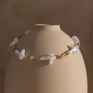 Hope Pearl Cross Bracelet with white pearl-style cross accents, polished gold-tone links and clear sparkling CZ stones